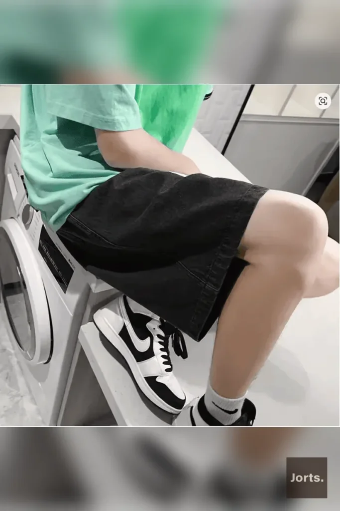 Back view of men's polyester shorts, highlighting the relaxed wide leg silhouette.