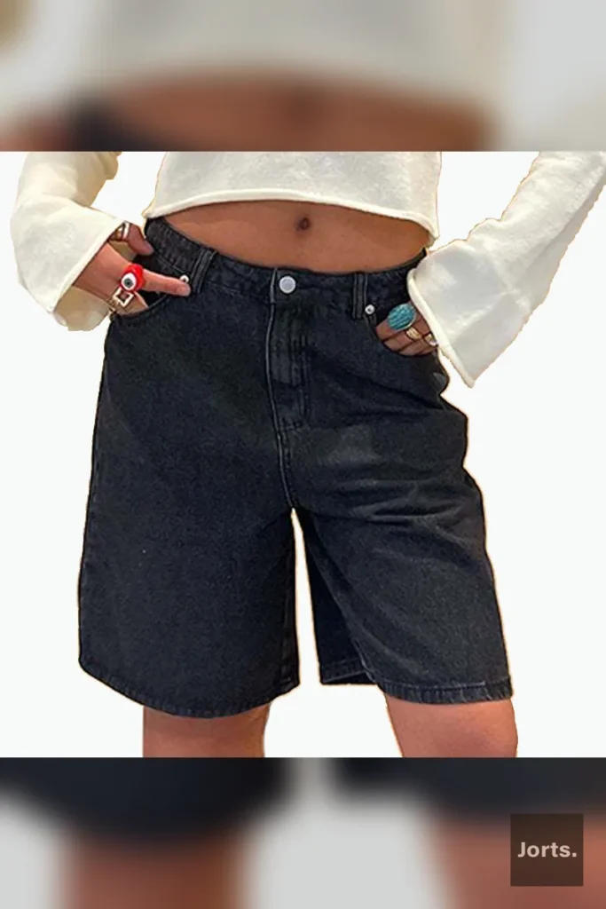 Close-up of washed dark blue cotton denim fabric on baggy cropped jorts.