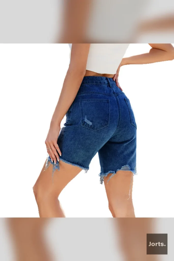 Texture shot of the rayon fabric used in the distressed cropped jorts, highlighting its drape.