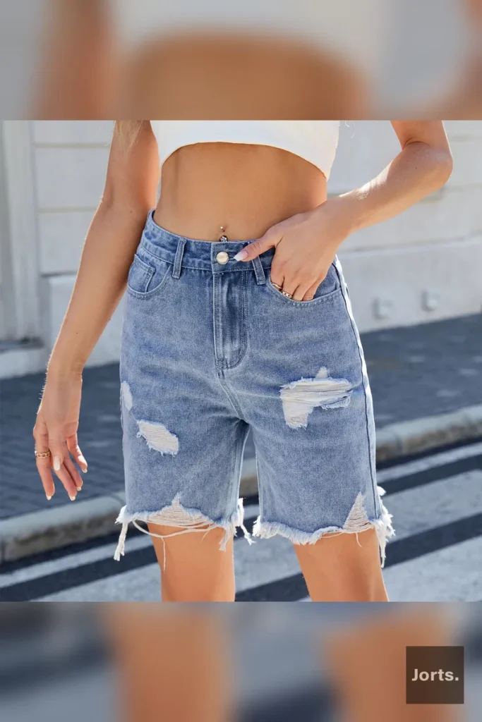 Model wearing black-gray distressed cropped jorts, styled for a casual Y2K streetwear look.
