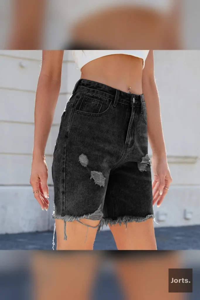 Side profile of women's distressed cropped jorts, showing the mid-waist and straight-leg silhouette.