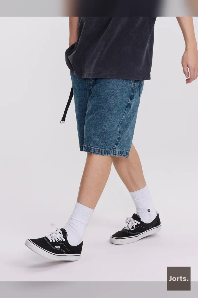Back view of men's dark blue cotton denim shorts showing solid color and fit