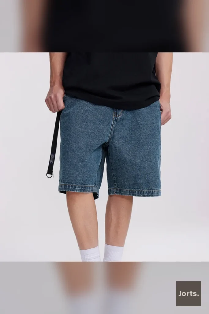 Teenager wearing men's dark denim shorts in a casual Y2K-inspired outfit, leisure scenario