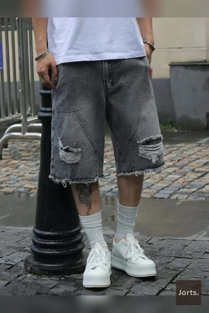 Mens gray denim jorts styled casually, perfect for everyday wear and channeling a nostalgic, relaxed Y2K aesthetic.