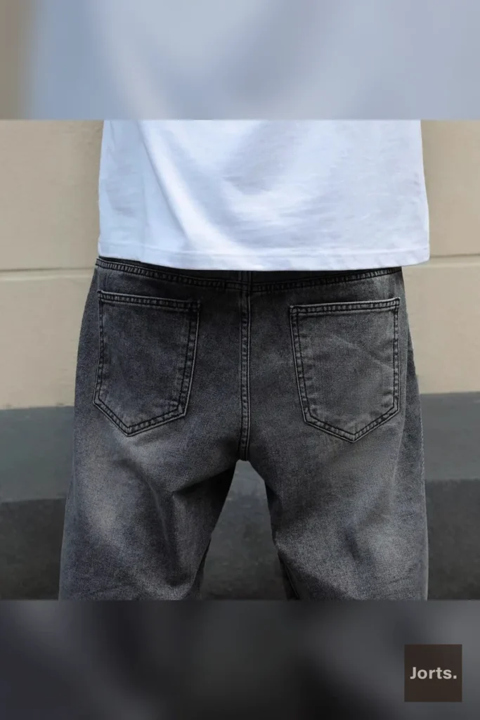 Side profile of mens gray denim jorts, highlighting the straight-leg cut and slight stretch fabric for comfortable movement.