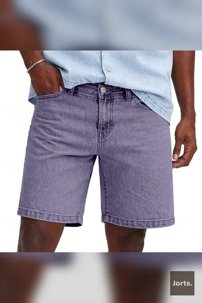 Model wearing rose red minimalist mens cropped denim jorts, styled casually for a summer look.