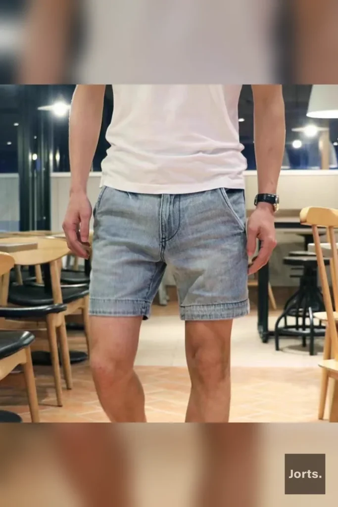 Side view of men's light blue washed denim jorts, showcasing the relaxed fit and cropped length for summer.