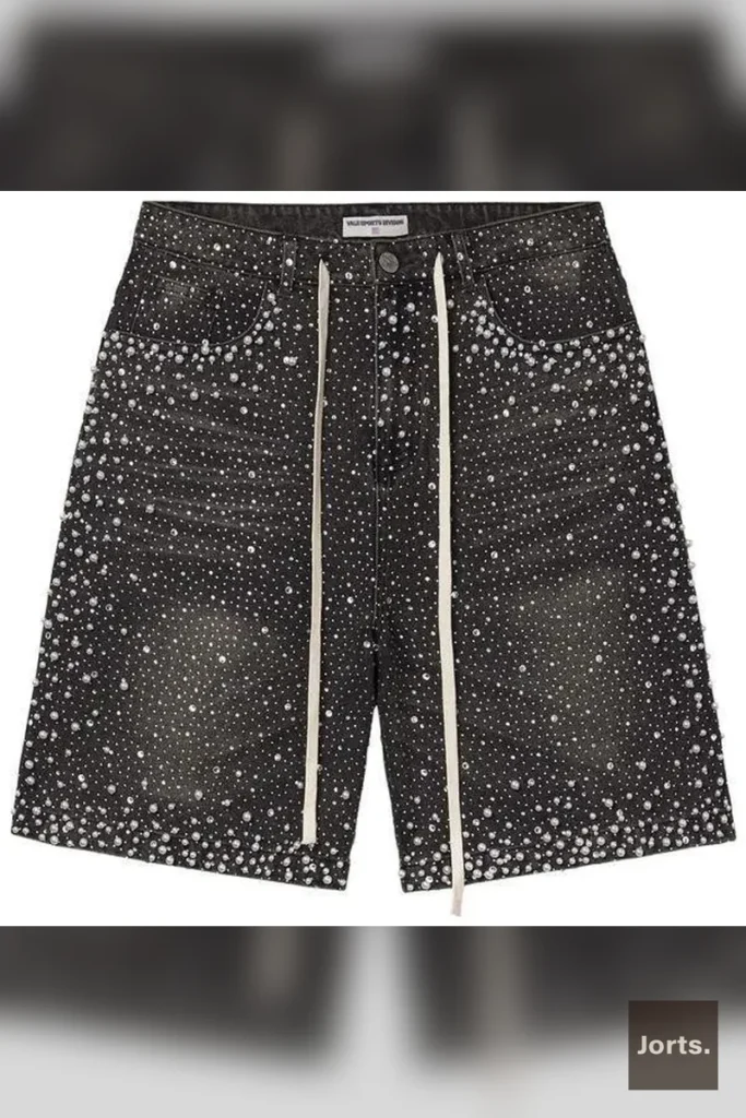 Model wearing rhinestone denim jorts as part of a complete Y2K streetwear outfit, showcasing the cropped length.