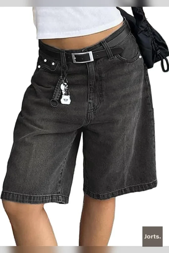 Woman wearing vintage mid-waist baggy cropped denim jorts in dark blue, styled for Y2K streetwear look.