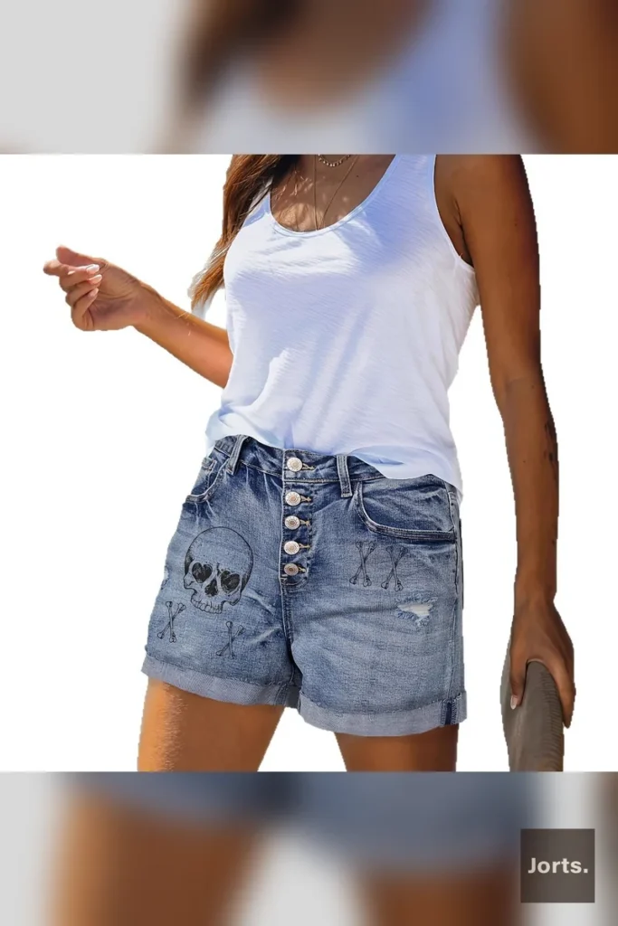 Close-up detail of the unique print and button closure on the vintage blue denim shorts