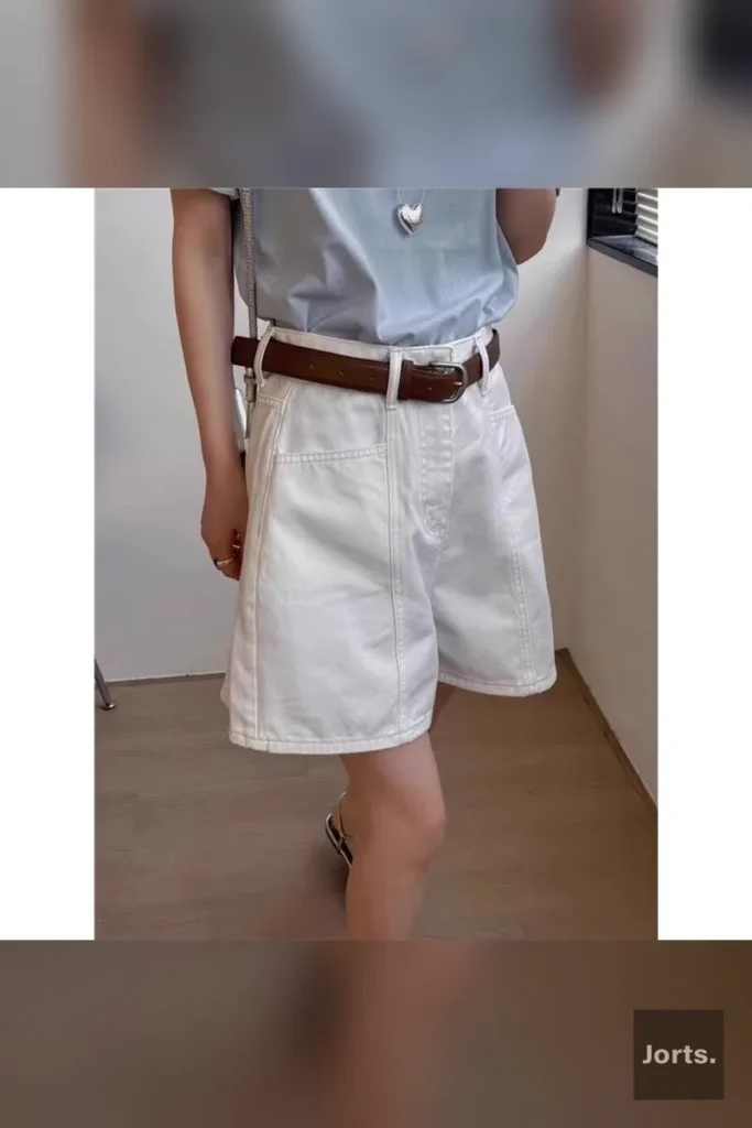 Rear view of the white high-waist cropped denim hot pants, highlighting the flattering cut and vintage-inspired design.