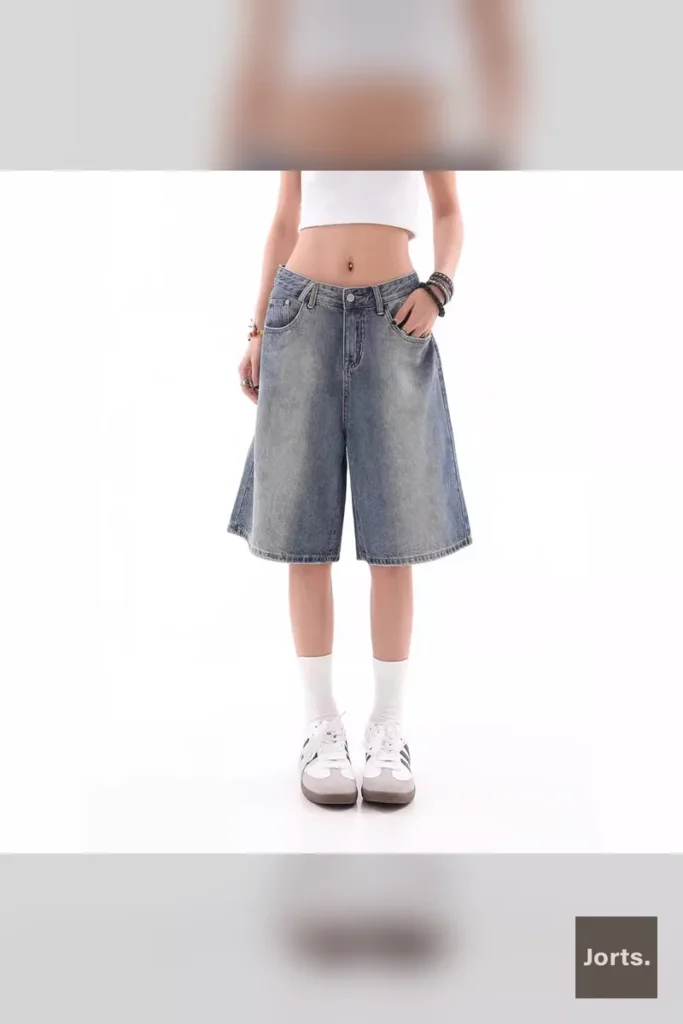 Woman posing in Y2K baggy denim shorts, full length shot