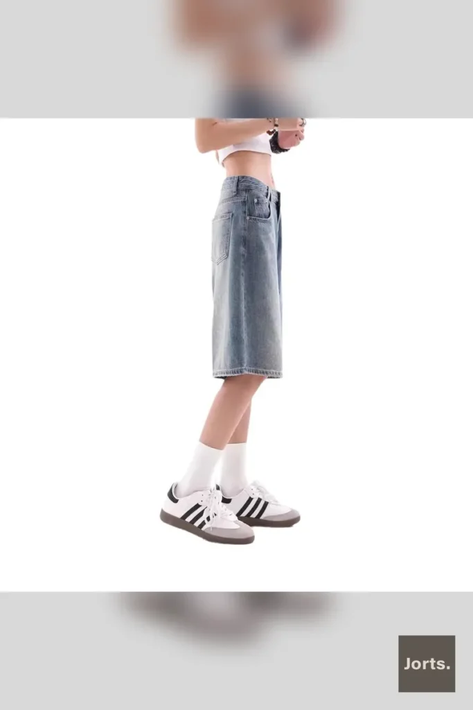 Woman wearing Y2K baggy denim shorts, front view, blue wash