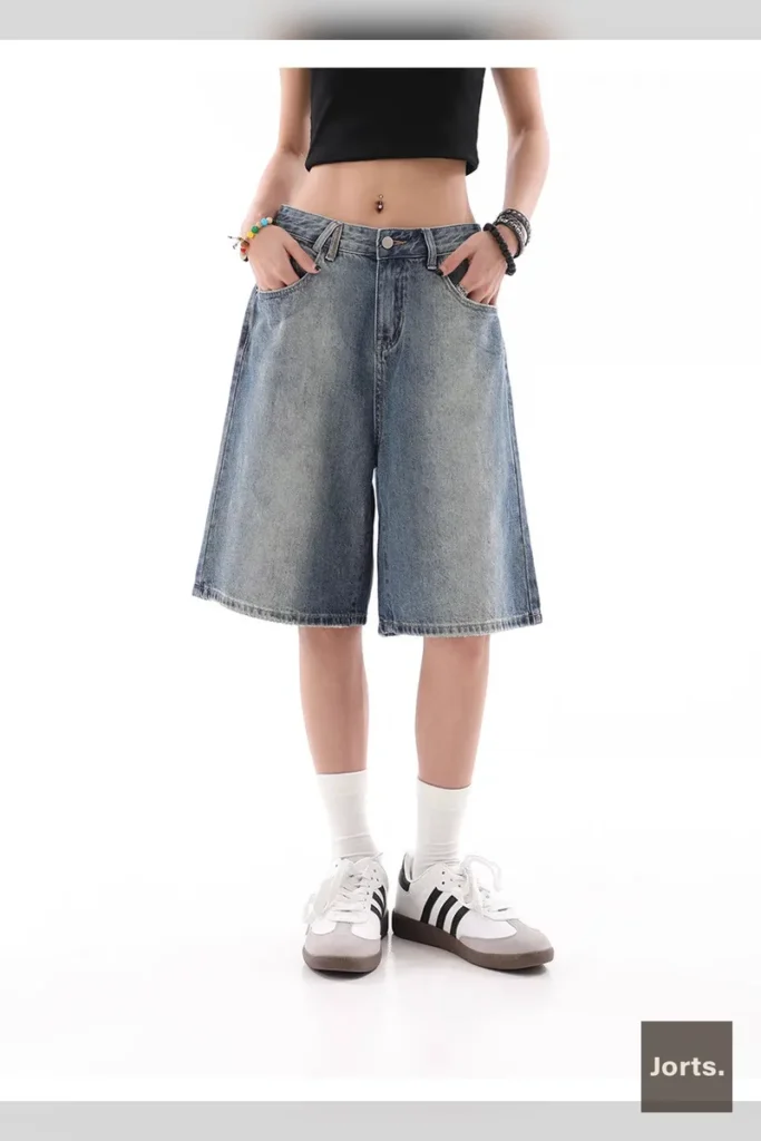 Woman wearing Y2K baggy denim shorts, side profile, blue wash