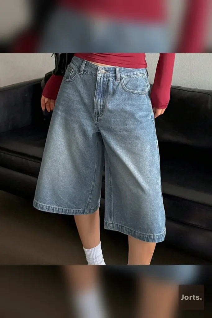 Close-up detail of the high-waist and button closure on the cropped baggy jorts.